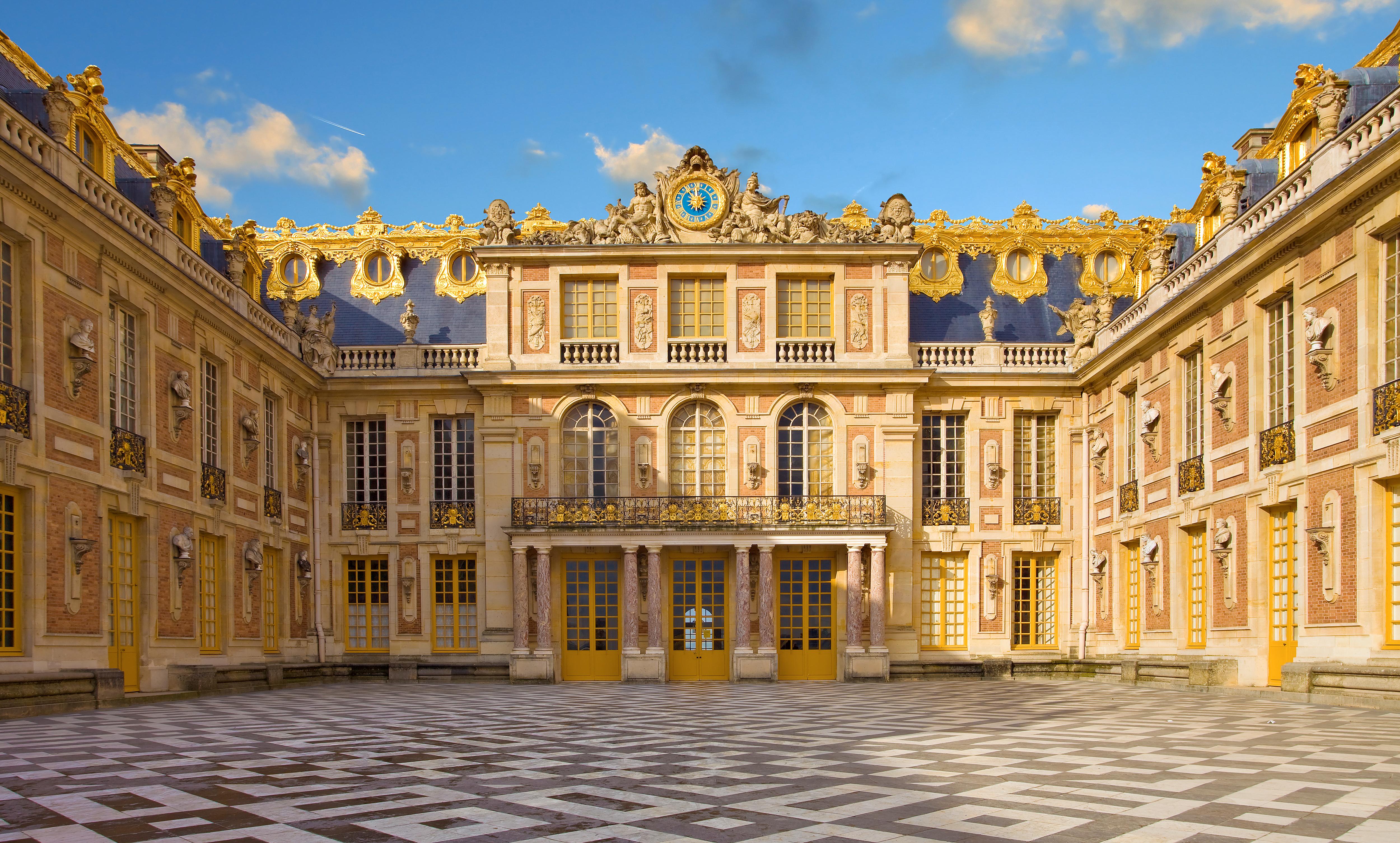 Palace of Versailles with grand Baroque architecture and ornate golden roofs