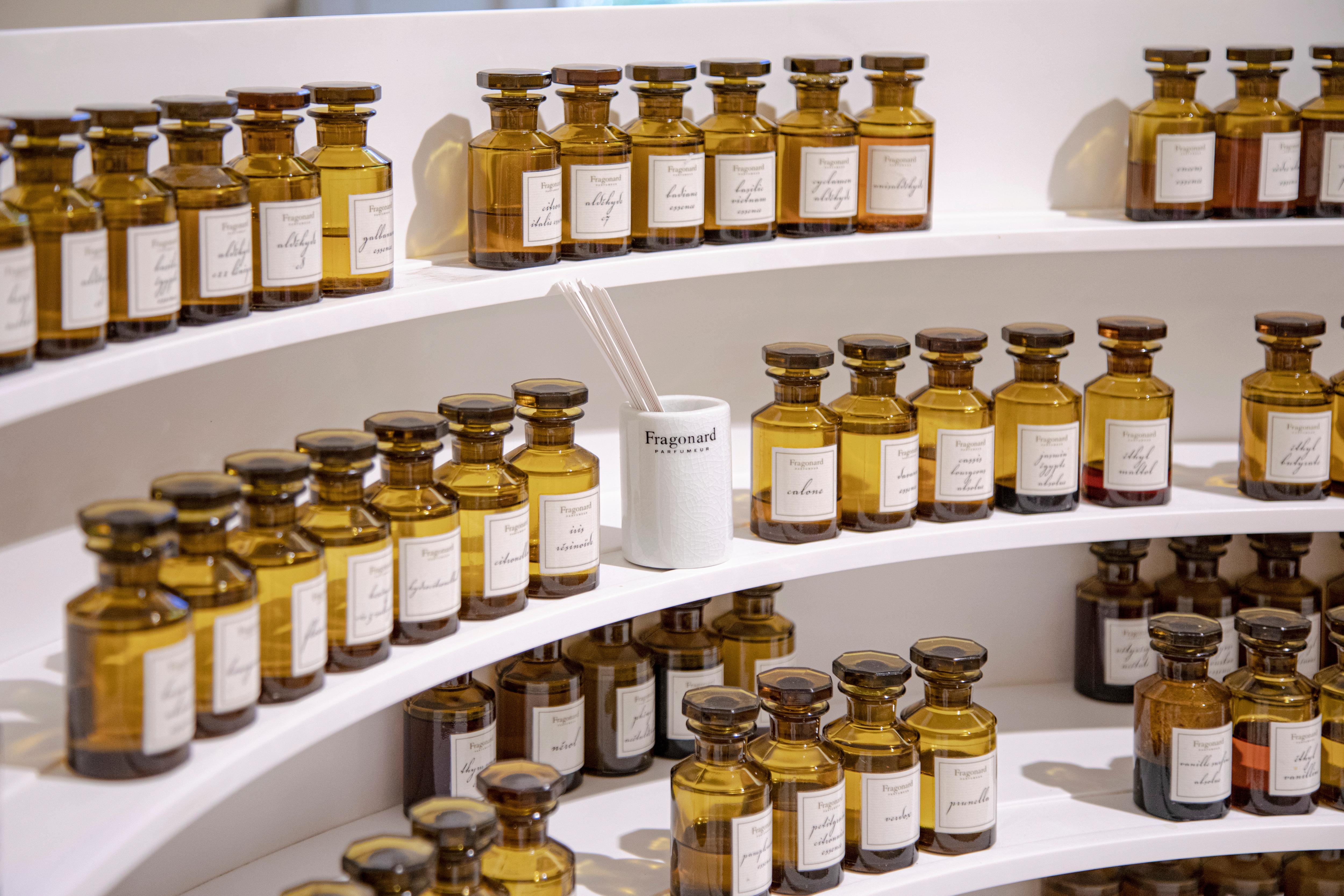 Amber glass bottles and fragrance products on modern shelving