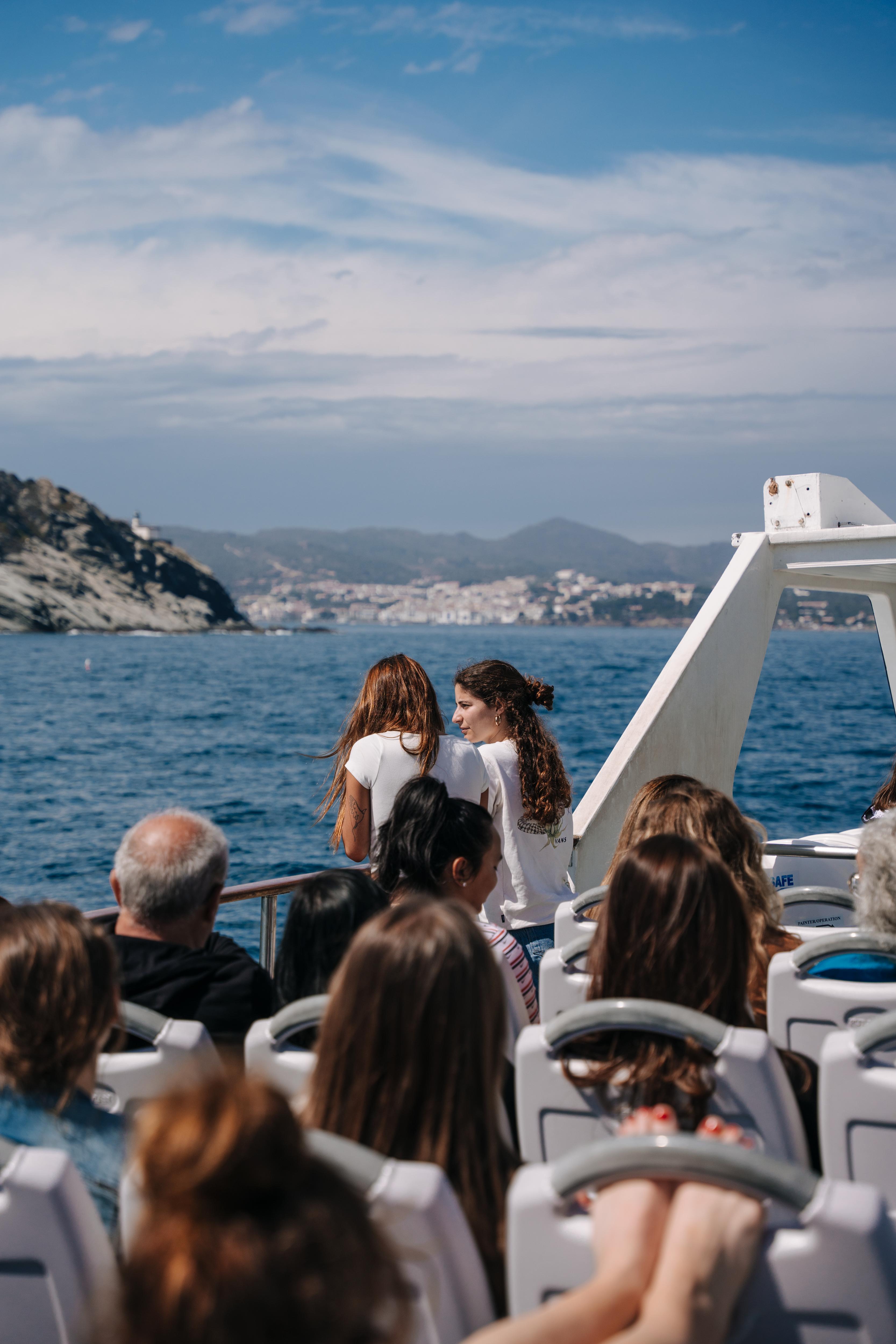 Students on a boat excursion, enjoying coastal views
