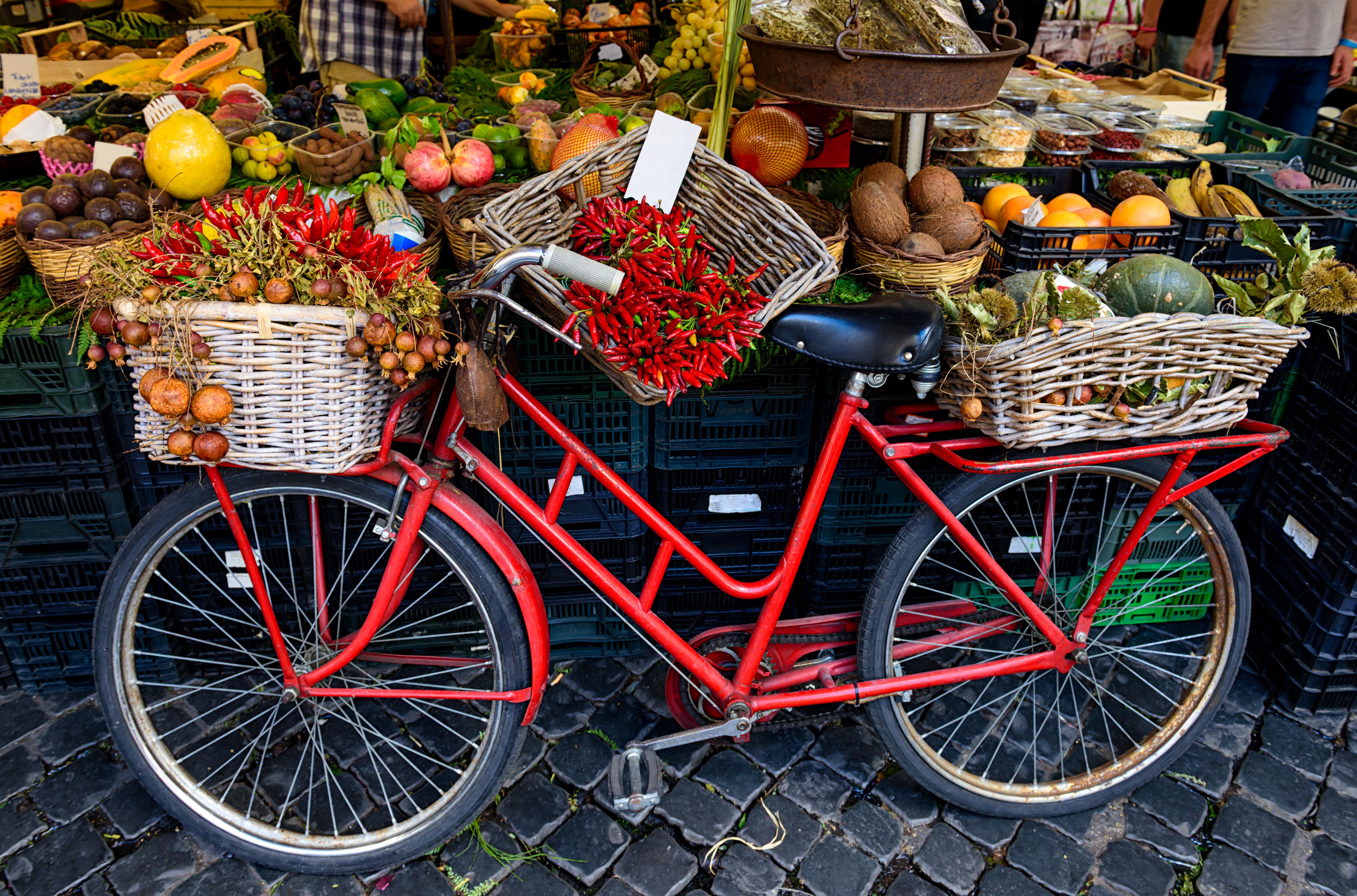 Bicycle loaded with fresh produce at a local market, showcasing vibrant food culture