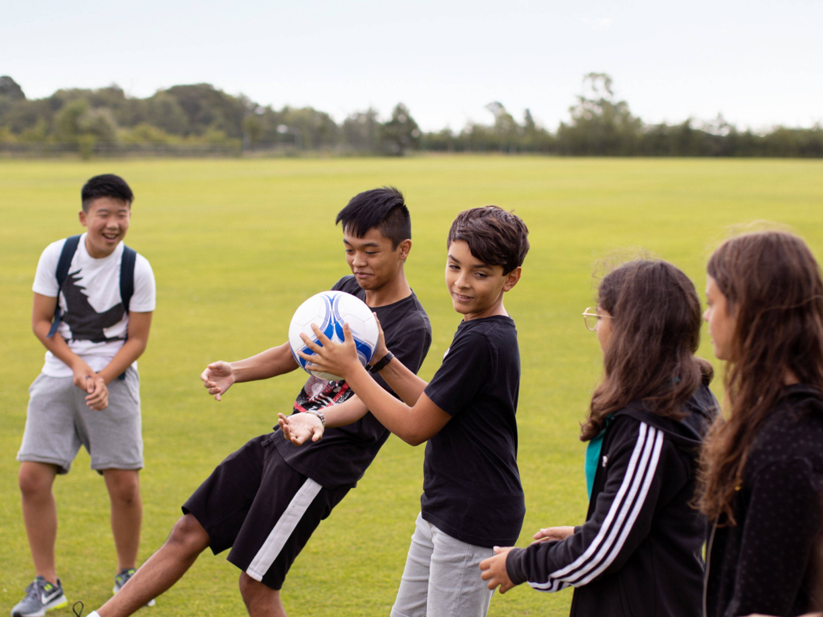 Students Playing In Field