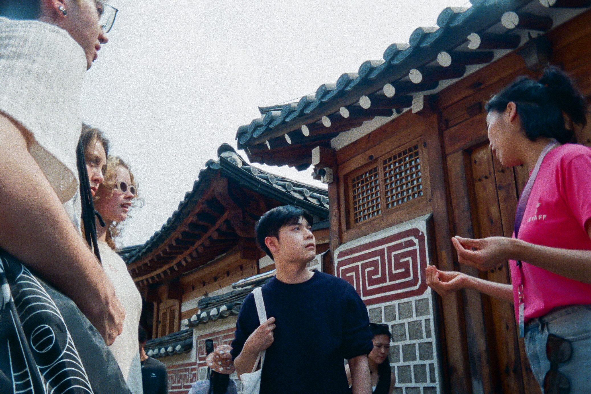 Students exploring a traditional Korean village with staff