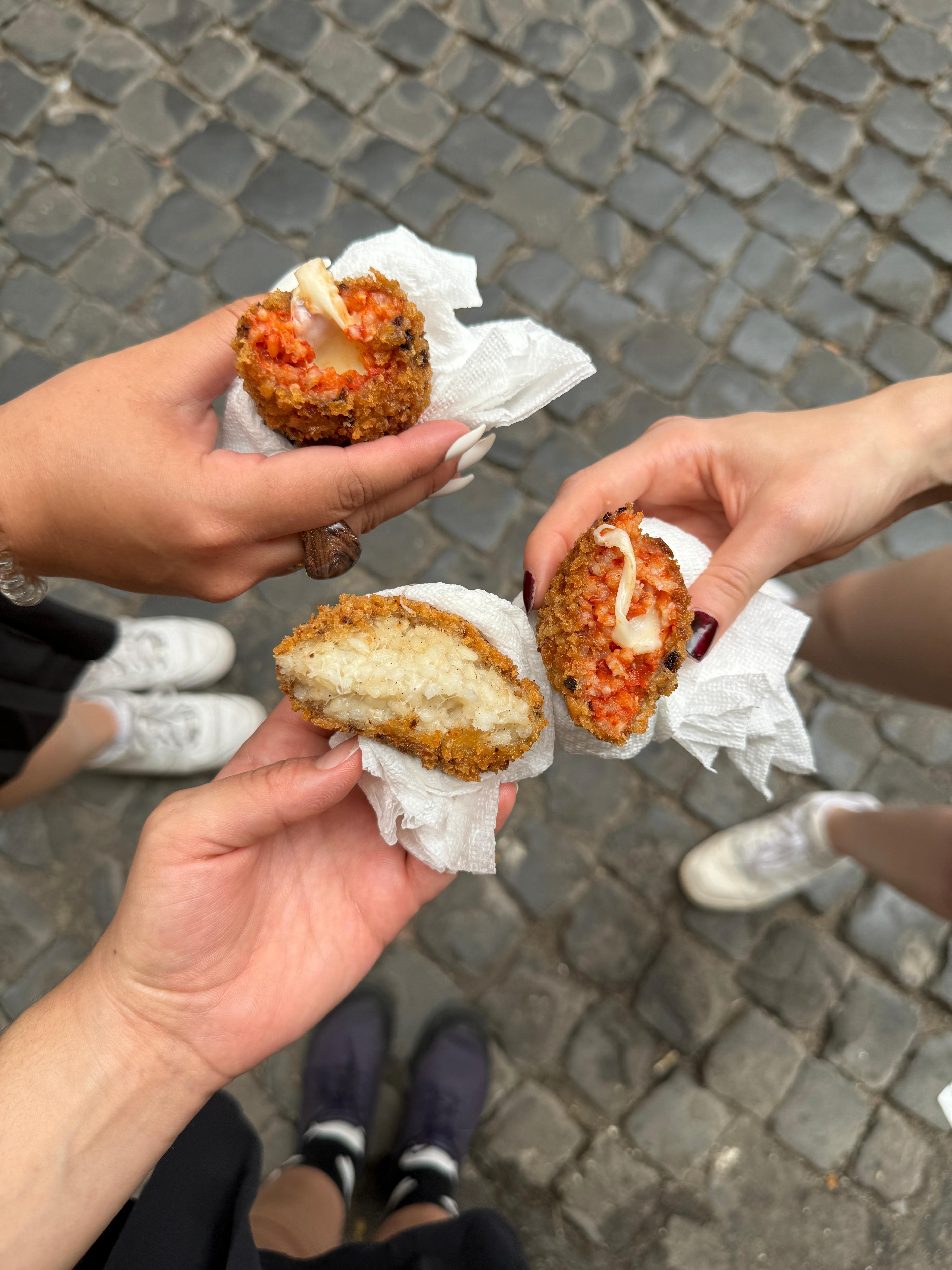 Students share a crispy, cheese-filled snack, enjoying food together