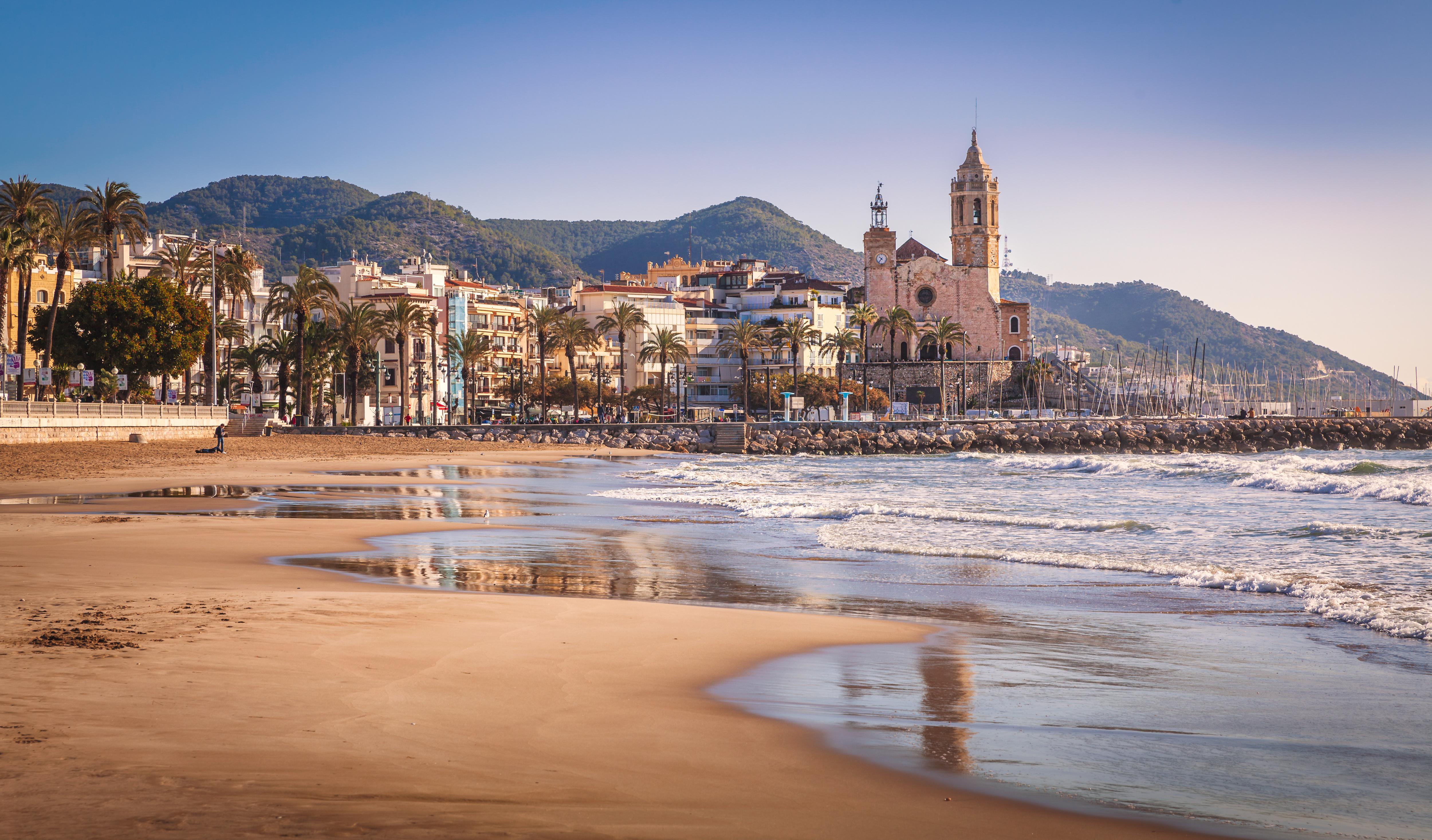 Platja de la Fragata beach and church view, showcasing Sitges’ scenic coastline
