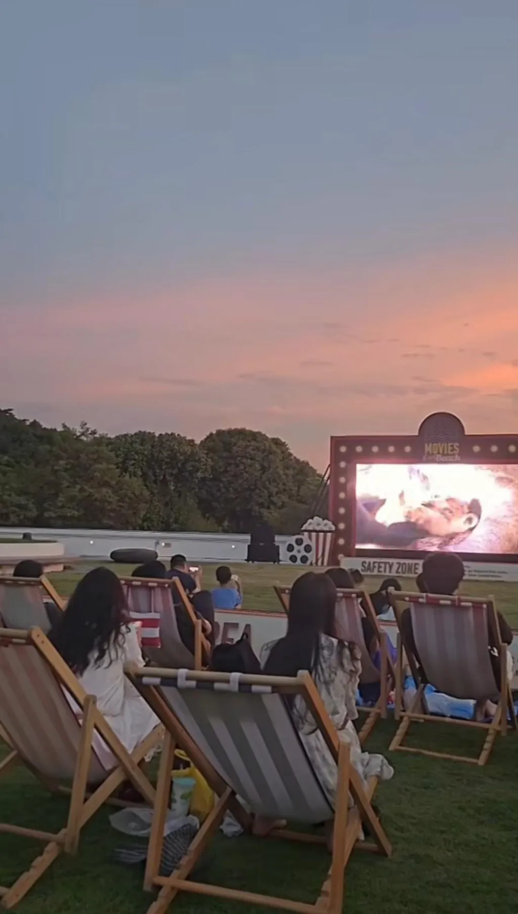Students enjoying an outdoor movie night at sunset