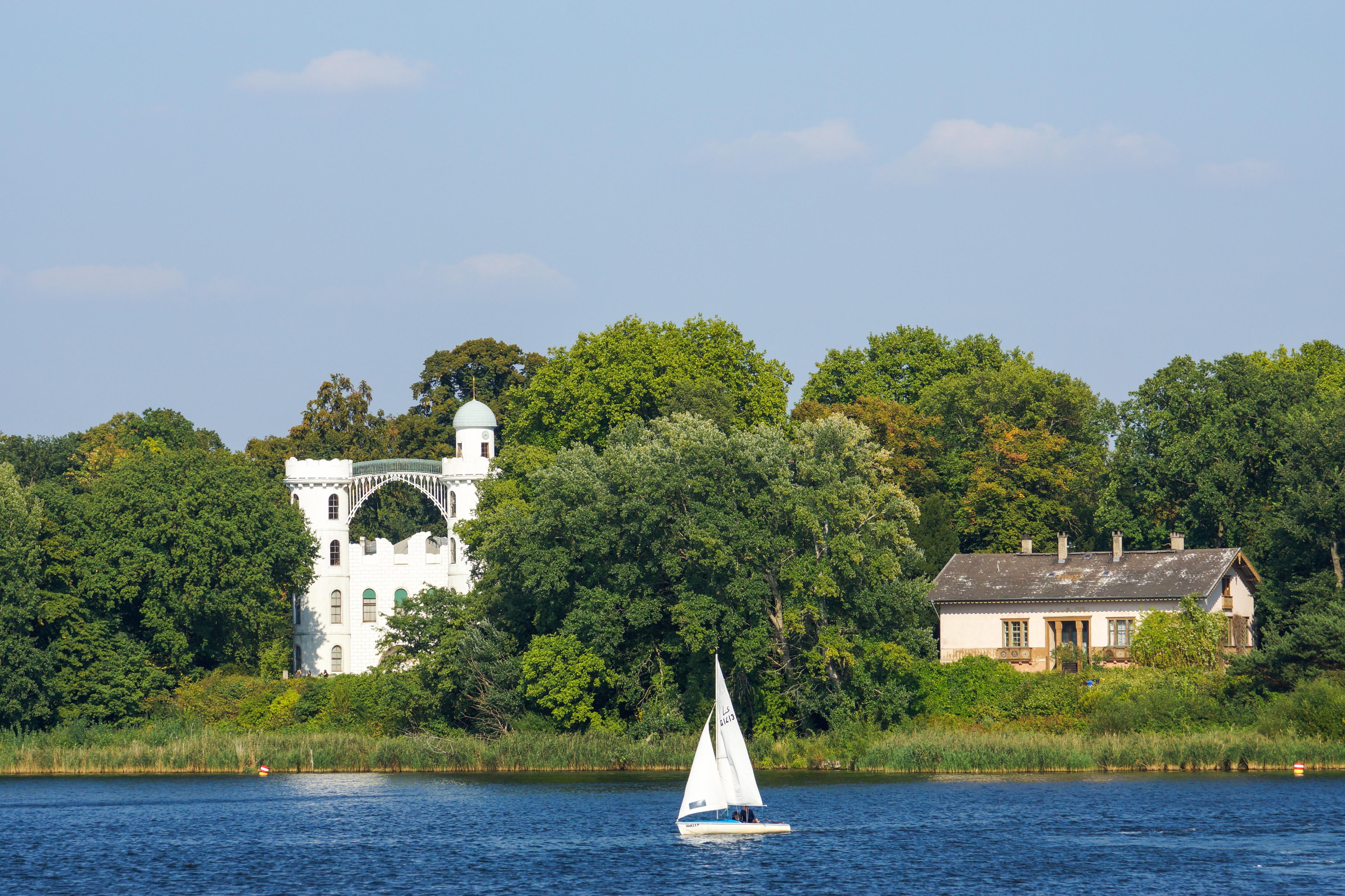 Pfaueninsel and Schloss on a tranquil lakeside, featuring historic architecture and scenic waterfront