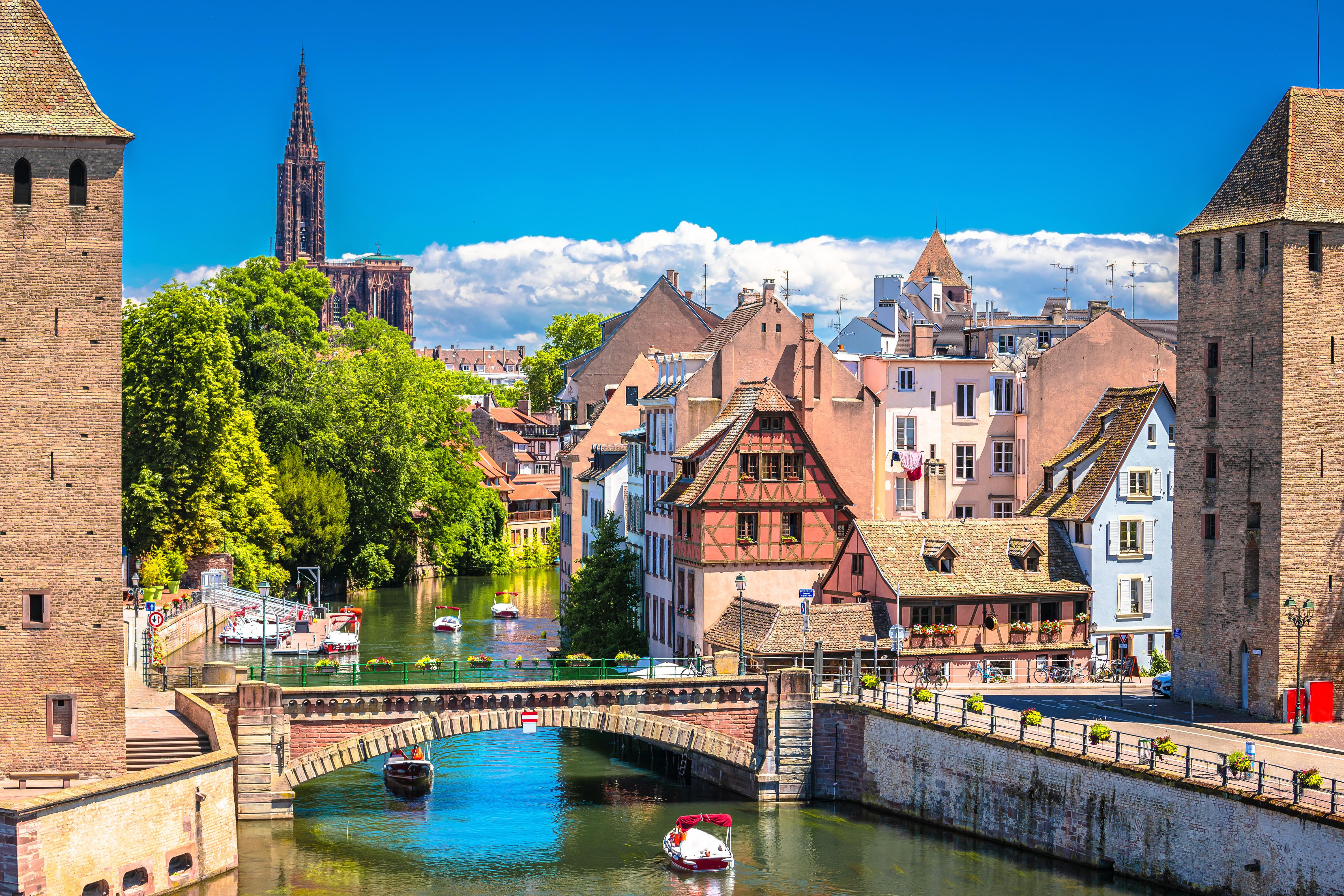 Strasbourg Cathedral, historic bridge, and riverboat overlooking the scenic cityscape