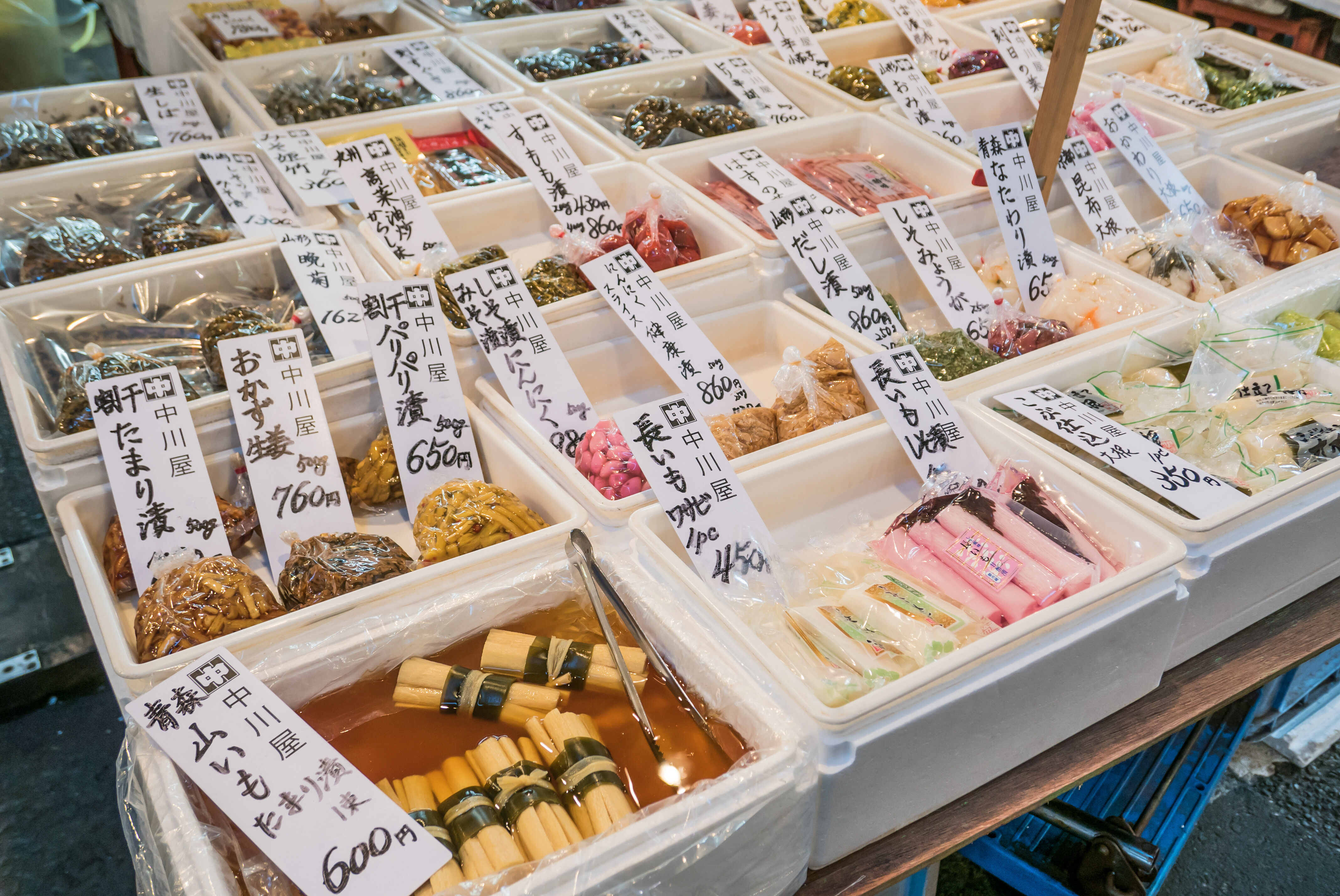 Assorted pickled foods displayed at a local market, showcasing traditional flavors and regional cuisine