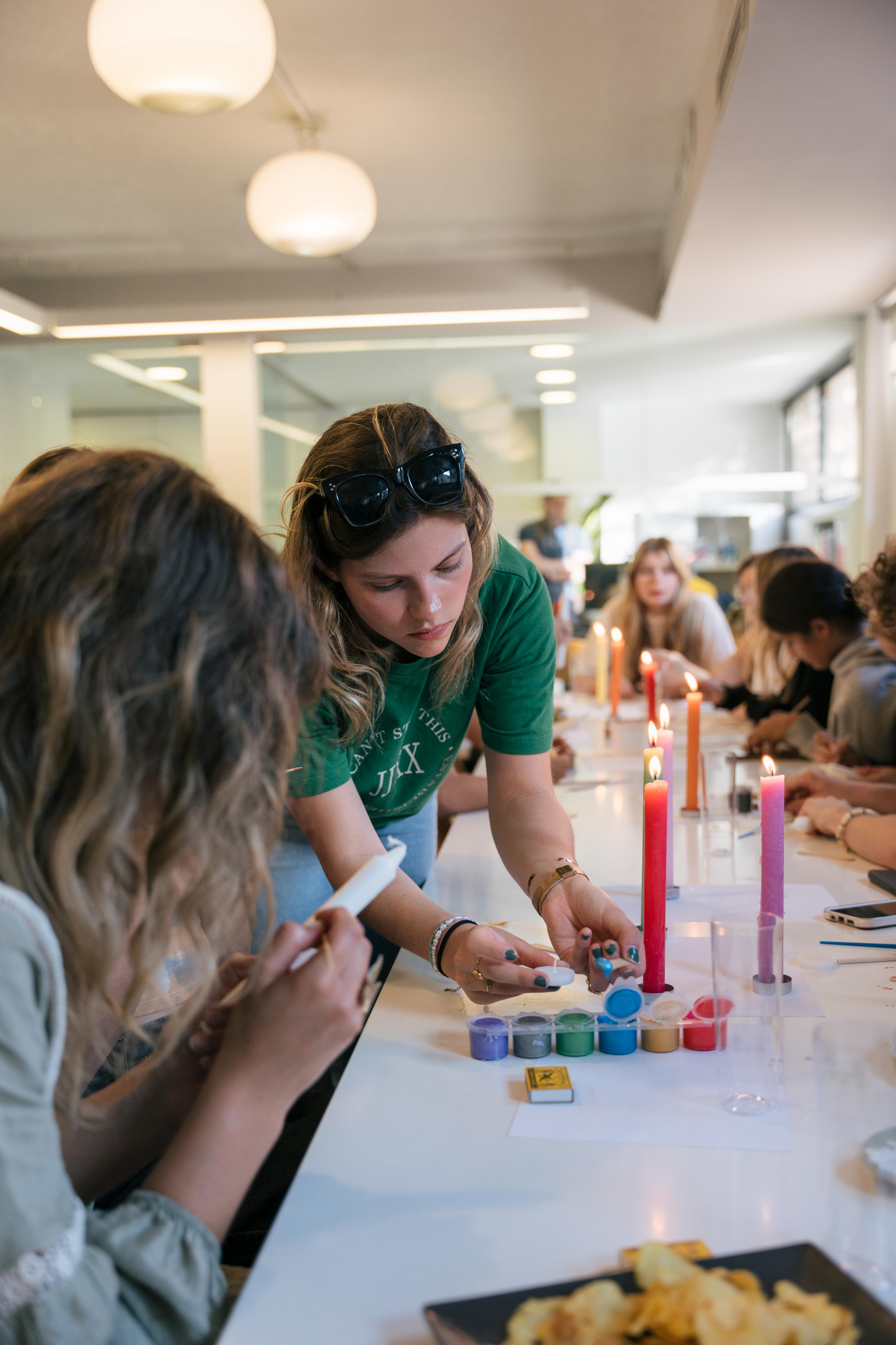 Students participate in a candle-making workshop, creating colorful crafts and collaborating in a fun, hands-on activity