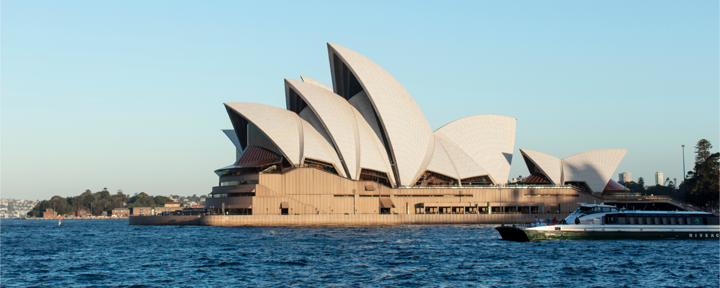 The Sydney Opera House, an iconic Australian landmark, sits by the harbor, a masterpiece of architecture with its distinctive white sails.