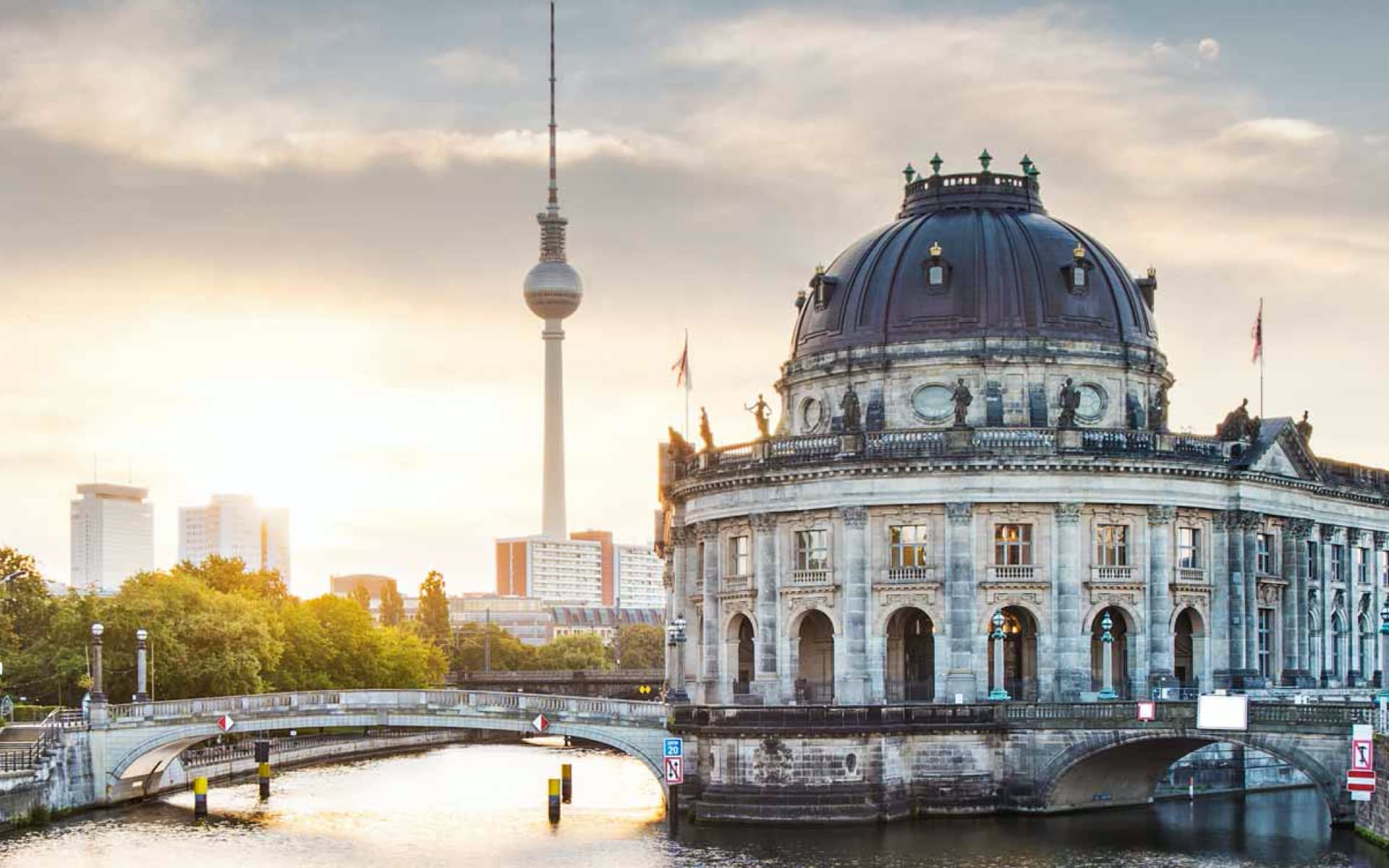 This image shows the Bode Museum in Berlin, Germany, with the Berlin TV Tower visible in the background across the Spree River.