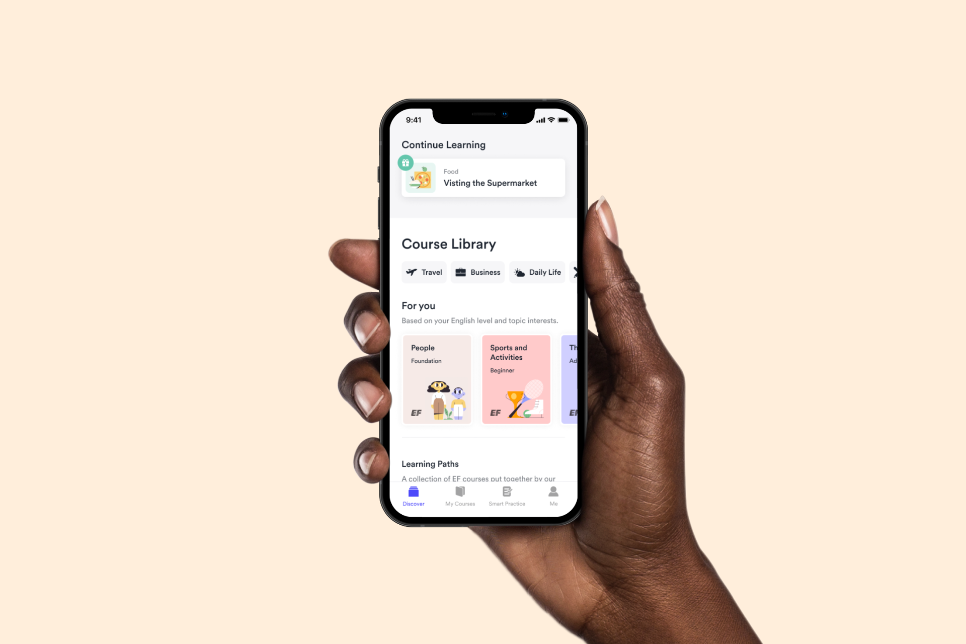 The image shows a hand holding a smartphone displaying a language learning app. The app features a "Course Library" with various learning categories and personalized recommendations for users.