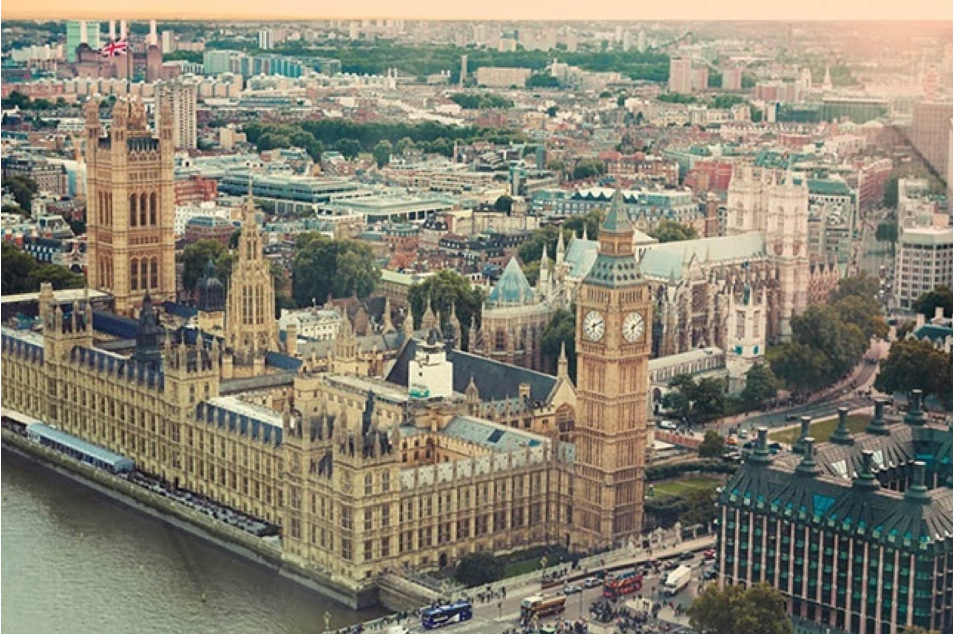 This image presents an aerial view of the Palace of Westminster in London, featuring the Elizabeth Tower (Big Ben) prominently. The River Thames flows in front, with the city sprawling behind.