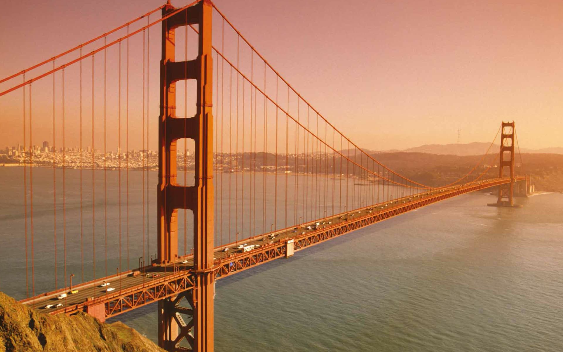 The Golden Gate Bridge at sunset, an iconic suspension bridge spanning San Francisco Bay, known for its vibrant orange color and stunning views.