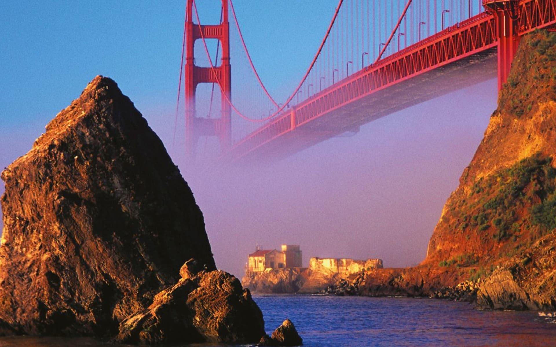 The Golden Gate Bridge in San Francisco, California, is an iconic suspension bridge, renowned for its vibrant red color and picturesque setting. It spans the Golden Gate strait, connecting the city to Marin County.